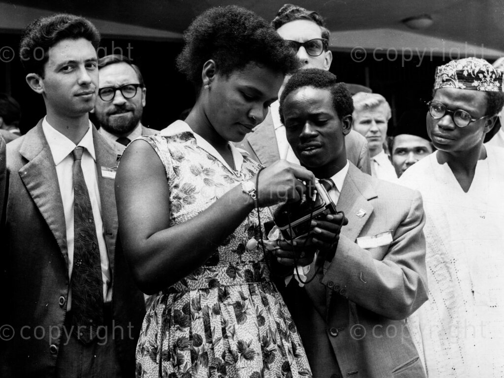 Young Folk Don't Forget – Florence Dillsworth Siera Leone with other students holding camera. Students from all over the world met at Ibadan, in the Western Region of Nigeria, to discuss their problems. They're still talking in different parts of the world about that cheery Nigerian hospitality. It will be a long time before the young men and women who attended the International Students Conference in Ibadan forget the enthusiasm with which they were greeted by Nigerians, rich and poor. The students discussed their common problems and ways of life. The Federal Government donated £600 and the West Regional Government £200 to help the Nigerian students to entertain their foreign guests.