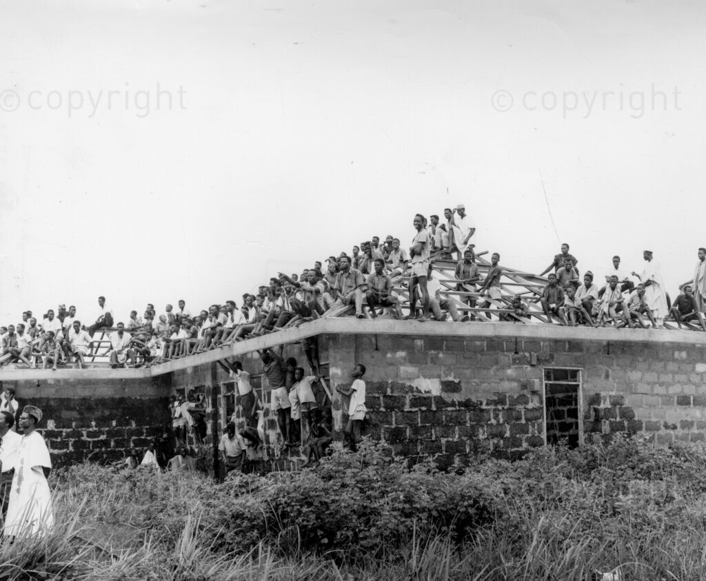 Despite the fear and the threats, Okpara triumphs In No-Man's Land. Okpara snaps the huge crowds. Dr Michael Okpara's meet-the-people-tour of Western Nigeria, apart from proving a bizarre mixture of incivility, escapism, hefty defence against non-existent troubles and a field day for journalistic zanies and radio cranks, was a glorious personal triumph for Dr Okpara's bravery and a confirmation that the people of Western Nigeria have not forgotten Chief Abafemi Awolowo and can still welcome any leader who comes along as his friend.