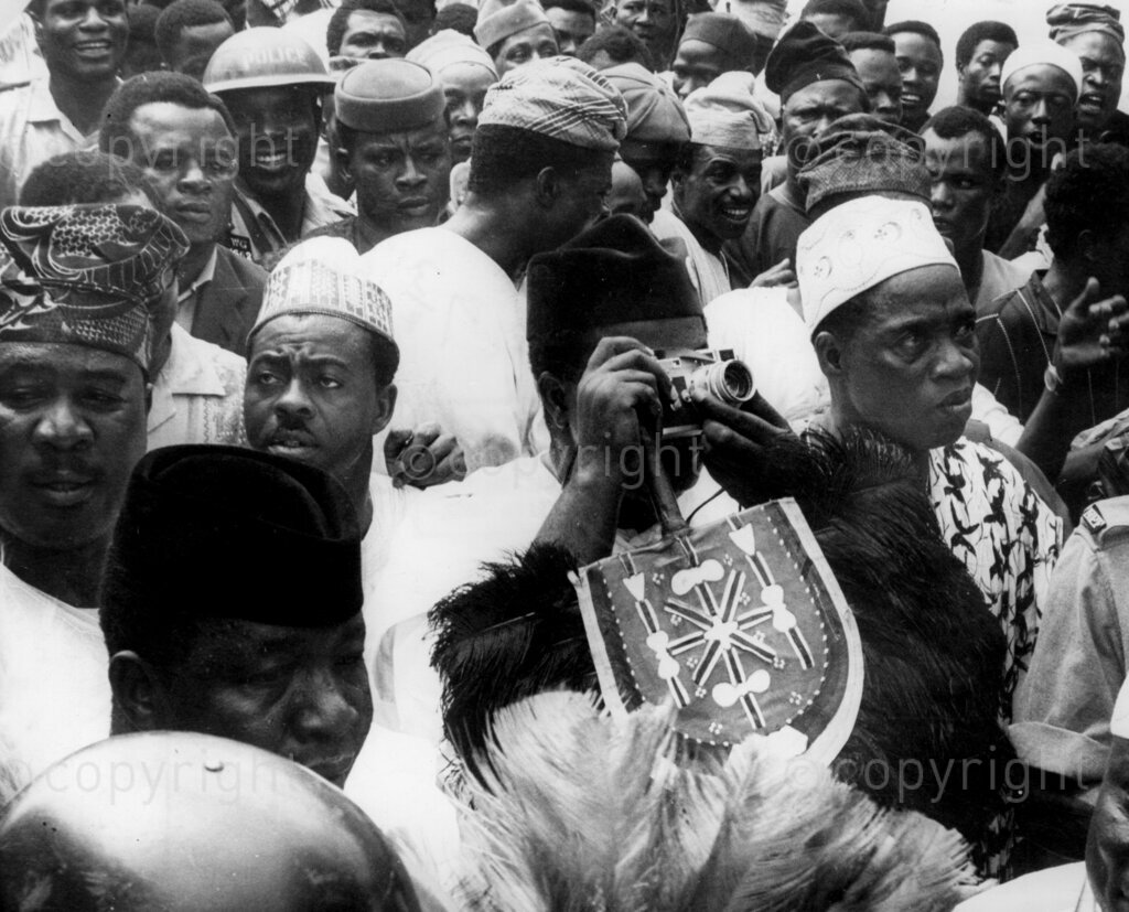 Despite the fear and the threats, Okpara triumphs In No-Man's Land. Okpara snaps the huge crowds. Dr Michael Okpara's meet-the-people-tour of Western Nigeria, apart from proving a bizarre mixture of incivility, escapism, hefty defence against non-existent troubles and a field day for journalistic zanies and radio cranks, was a glorious personal triumph for Dr Okpara's bravery and a confirmation that the people of Western Nigeria have not forgotten Chief Abafemi Awolowo and can still welcome any leader who comes along as his friend.