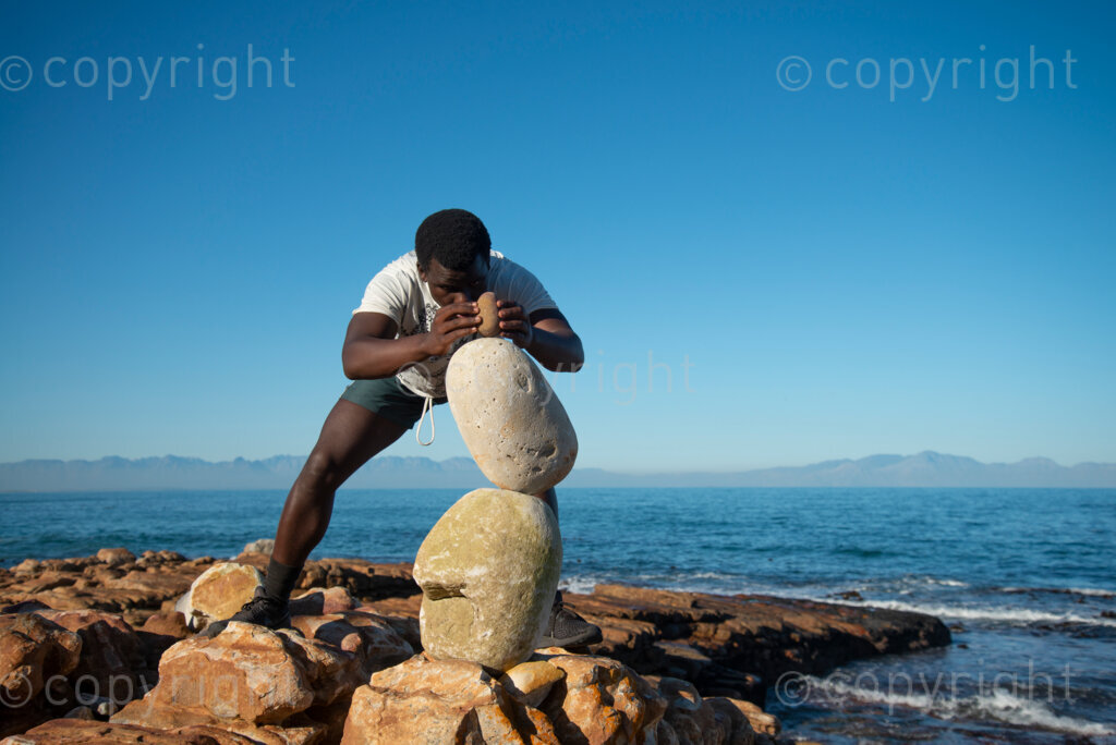 Sipho Njengezi balances rocks in Kalk Bay, Cape Town, on Thursday afternoon, July 17, 2020. PHOTO: EVA-LOTTA JANSSON 