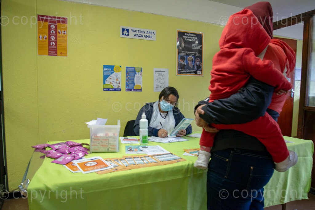 Nurse Vivienne Wese screens patients for TB and COVID-19 as they arrive, today when the City of Cape Town opened a clinic extension in the Elsies River Library, to serve mothers and children with routine visits such as family planning and immunizations, Monday, July 13, 2020. Clinic extensions are being constructed to separate COVID-19 treatment and diagnosis from other treatments. 