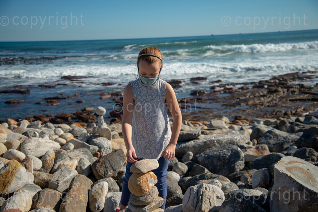 Rock artist Lara Thompson's daugther Shae, 12, demonstrates how they hide her mother's rocks for people to find near Slangkop light house in Kommetjie, Cape Town, Thursday, July 17, 2020. PHOTO: EVA-LOTTA JANSSON 