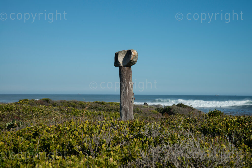 A stone is stacked on top of an old fence pole near Slangkop light house in Kommetjie, Cape Town, Thursday, July 17, 2020. PHOTO: EVA-LOTTA JANSSON 