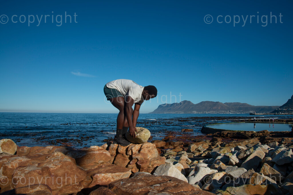 Sipho Njengezi balances rocks in Kalk Bay, Cape Town, on Thursday afternoon, July 17, 2020. PHOTO: EVA-LOTTA JANSSON 