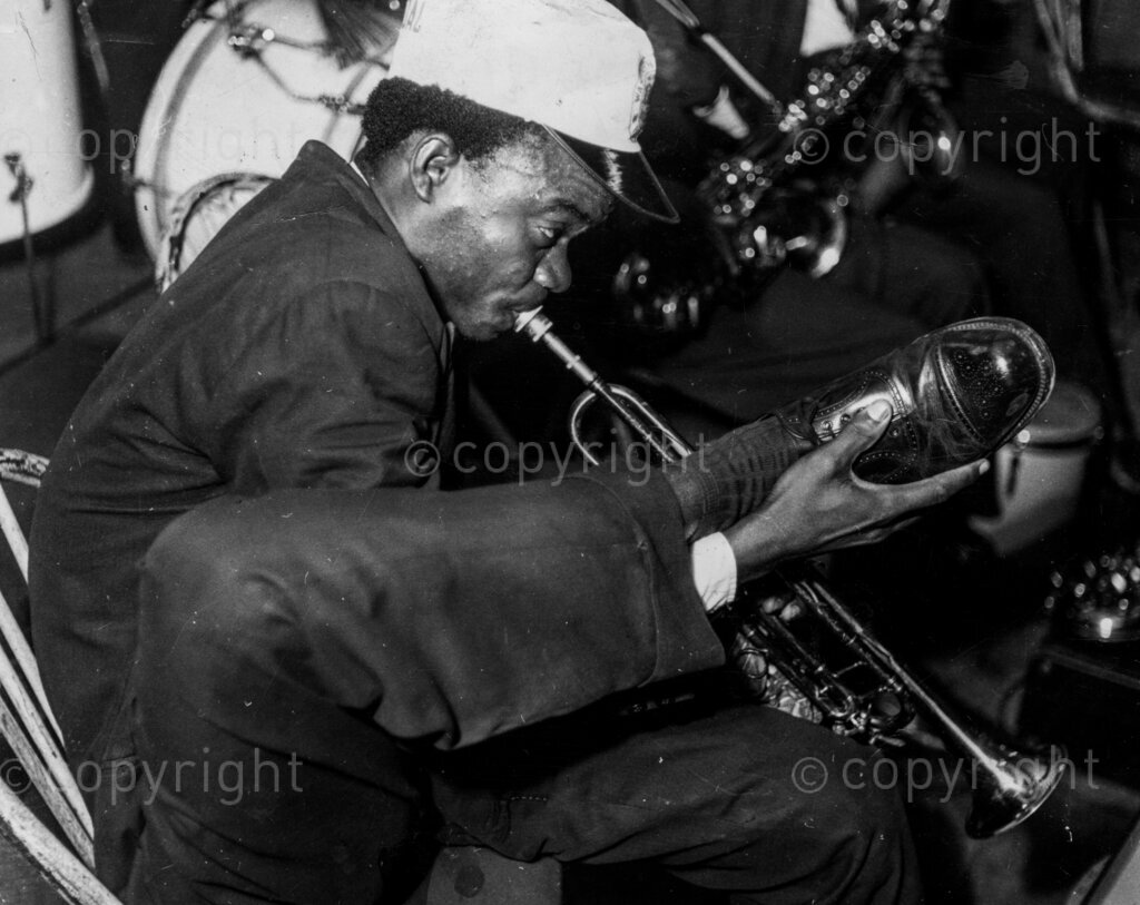 Nigeria's Hi-De-Jazzman; Zeal Onyia. His long fingers over-worked, his lithe feet take a turn. When he plays the silvery, talking, trumpet, the folks flock to him like the rats of Hamelin flocked to the Pied Piper. He's the boy who nurses the ambition to Satchmo like Louis Armstrong in jazz trumpeting. Zeal Onyia started playing the flute at the age of four, played the drums at the age of eight, blew the trombone at the age of eleven, and the trumpet at the age of fifteen.