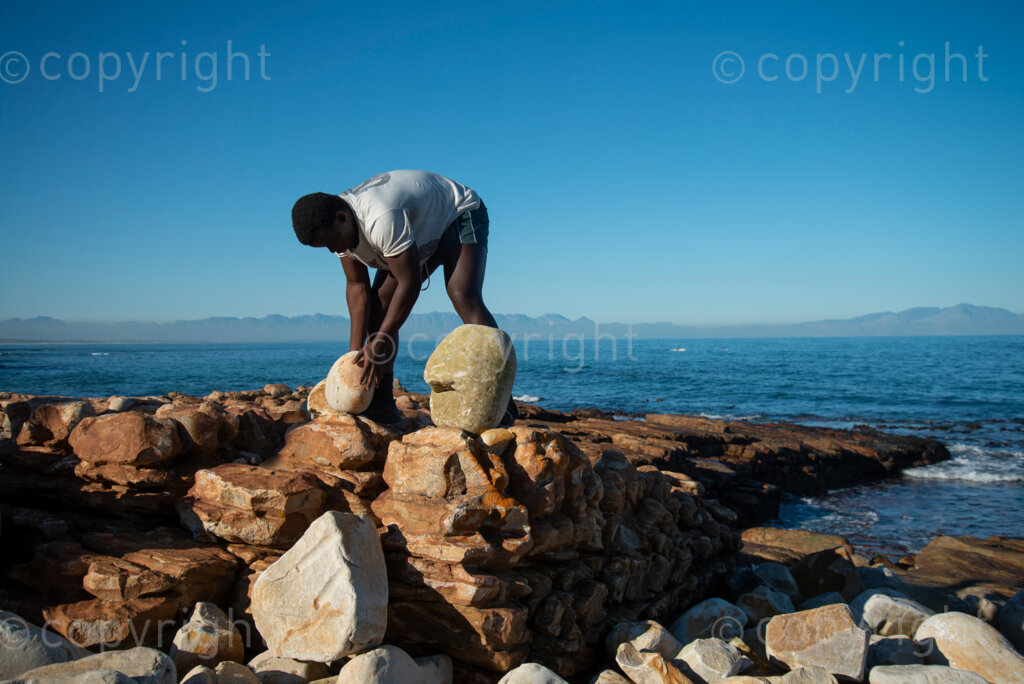 Sipho Njengezi balances rocks in Kalk Bay, Cape Town, on Thursday afternoon, July 17, 2020. PHOTO: EVA-LOTTA JANSSON 