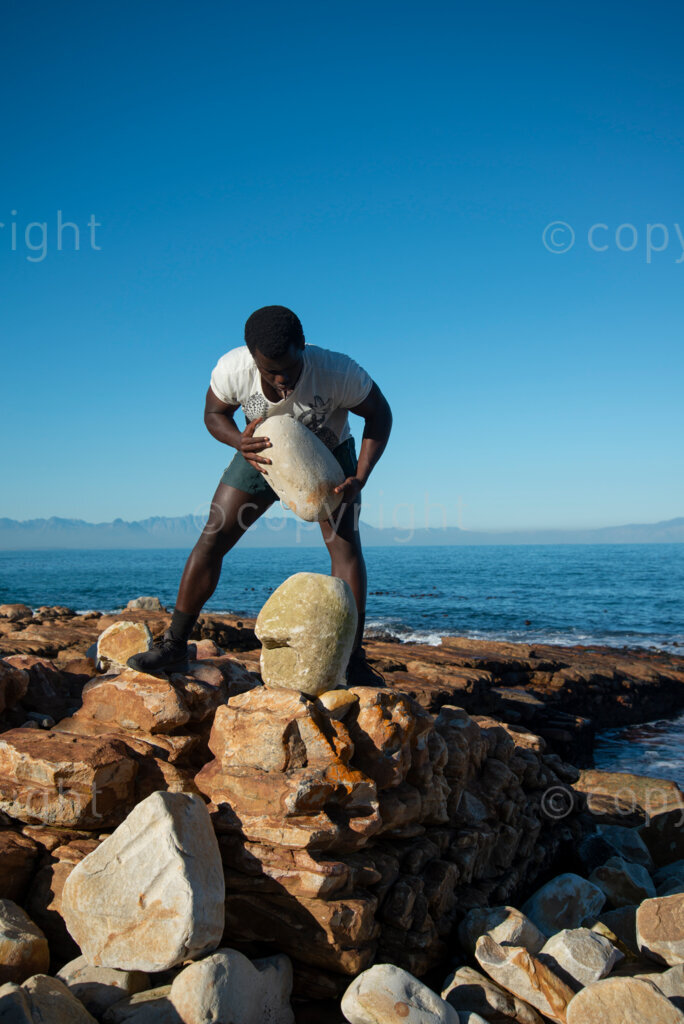Sipho Njengezi balances rocks in Kalk Bay, Cape Town, on Thursday afternoon, July 17, 2020. PHOTO: EVA-LOTTA JANSSON 
