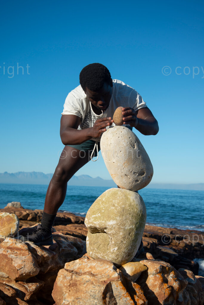 Sipho Njengezi balances rocks in Kalk Bay, Cape Town, on Thursday afternoon, July 17, 2020. PHOTO: EVA-LOTTA JANSSON 