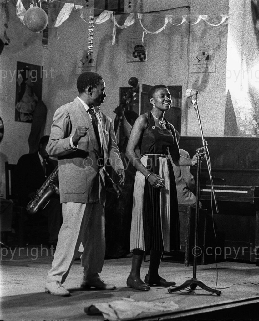 Miriam Makeba and The Manhattan Brothers – A year ago (1955) the Manhattan Brothers discovered a great voice in Miriam Makeba. Then she was just a small-town girl with a voice, which was about all she had. They saw possibilities in her and signed her for a year. The Nightingale. A Ball of Fire!