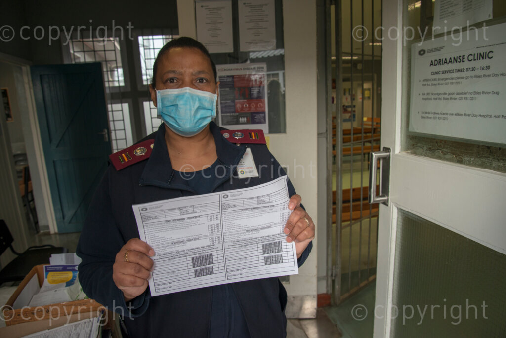 Clinic Manager Marilyn Jantjies holds up a screening sheet for TB and COVID-19 at the entrance of the Adriaanse Clinic in Elsies River, Cape Town, Monday, July 13, 2020. All patients are screened verbally for COVID-19 at the clinic door, and are asked to go to the hospital for a test if they screen positive. Although many health facilities in the area have experienced their health workers contracting COVID-19, Jantjies says nobody on her staff has yet taken ill. PHOTO: EVA-LOTTA JANSSON 