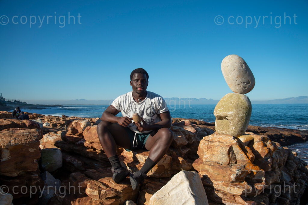 Sipho Njengezi balances rocks in Kalk Bay, Cape Town, on Thursday afternoon, July 17, 2020. PHOTO: EVA-LOTTA JANSSON 