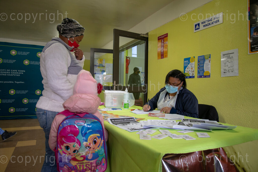 Nurse Vivienne Wese screens patients for TB and COVID-19 as they arrive, today when the City of Cape Town opened a clinic extension in the Elsies River Library, to serve mothers and children with routine visits such as family planning and immunizations, Monday, July 13, 2020. Clinic extensions are being constructed to separate COVID-19 treatment and diagnosis from other treatments. 