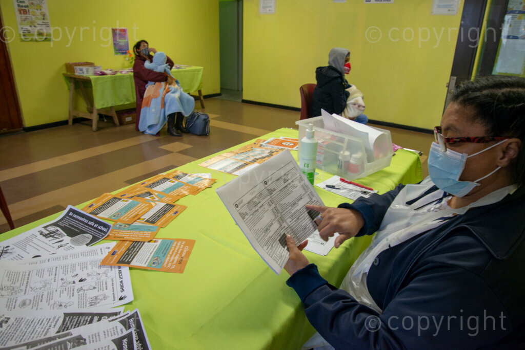 Nurse Vivienne Wese screens patients for TB and COVID-19 as they arrive, today when the City of Cape Town opened a clinic extension in the Elsies River Library, to serve mothers and children with routine visits such as family planning and immunizations, Monday, July 13, 2020. Clinic extensions are being constructed to separate COVID-19 treatment and diagnosis from other treatments. 