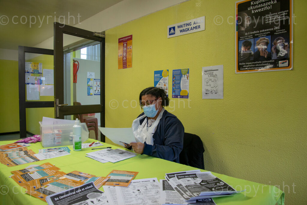 Nurse Vivienne Wese screens patients for TB and COVID-19 as they arrive, today when the City of Cape Town opened a clinic extension in the Elsies River Library, to serve mothers and children with routine visits such as family planning and immunizations, Monday, July 13, 2020. Clinic extensions are being constructed to separate COVID-19 treatment and diagnosis from other treatments. 