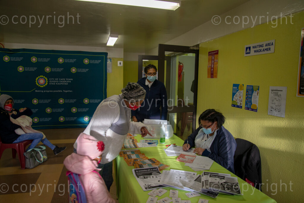 Nurse Vivienne Wese screens patients for TB and COVID-19 as they arrive, today when the City of Cape Town opened a clinic extension in the Elsies River Library, to serve mothers and children with routine visits such as family planning and immunizations, Monday, July 13, 2020. Clinic extensions are being constructed to separate COVID-19 treatment and diagnosis from other treatments. 