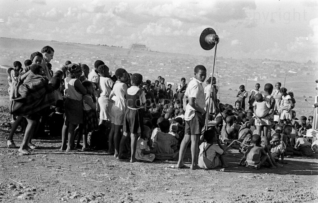 The Shut-down On African Education – A black cloud is sweeping over African education today. There is a pincer movement closing in centres of learning. In primary schools that unfortunate Bantu Education Act arrived! Masses of parents, under the banner of the African National Congress, particularly on the Reef, went on boycott from the fatal day of April 1 by withdrawing their children from schools. And the Government's reply? Numbers of children who did not turn up for school by and on 25 April have been banned from schooling anywhere in the Union. As a result, of a total number of 6,948 pupils coming under this ban, 116 teachers in all have been served with a month's notice to leave school. The school, going population outside school has thus increased immensely. Banned pupils, sacked teachers, half-empty schools.