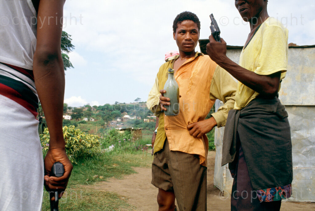 KwaMashu, KwaZulu  Natal, South Africa, 1994. ANC supporters with a homemade gun or kwash during clashes with  IFP suppo